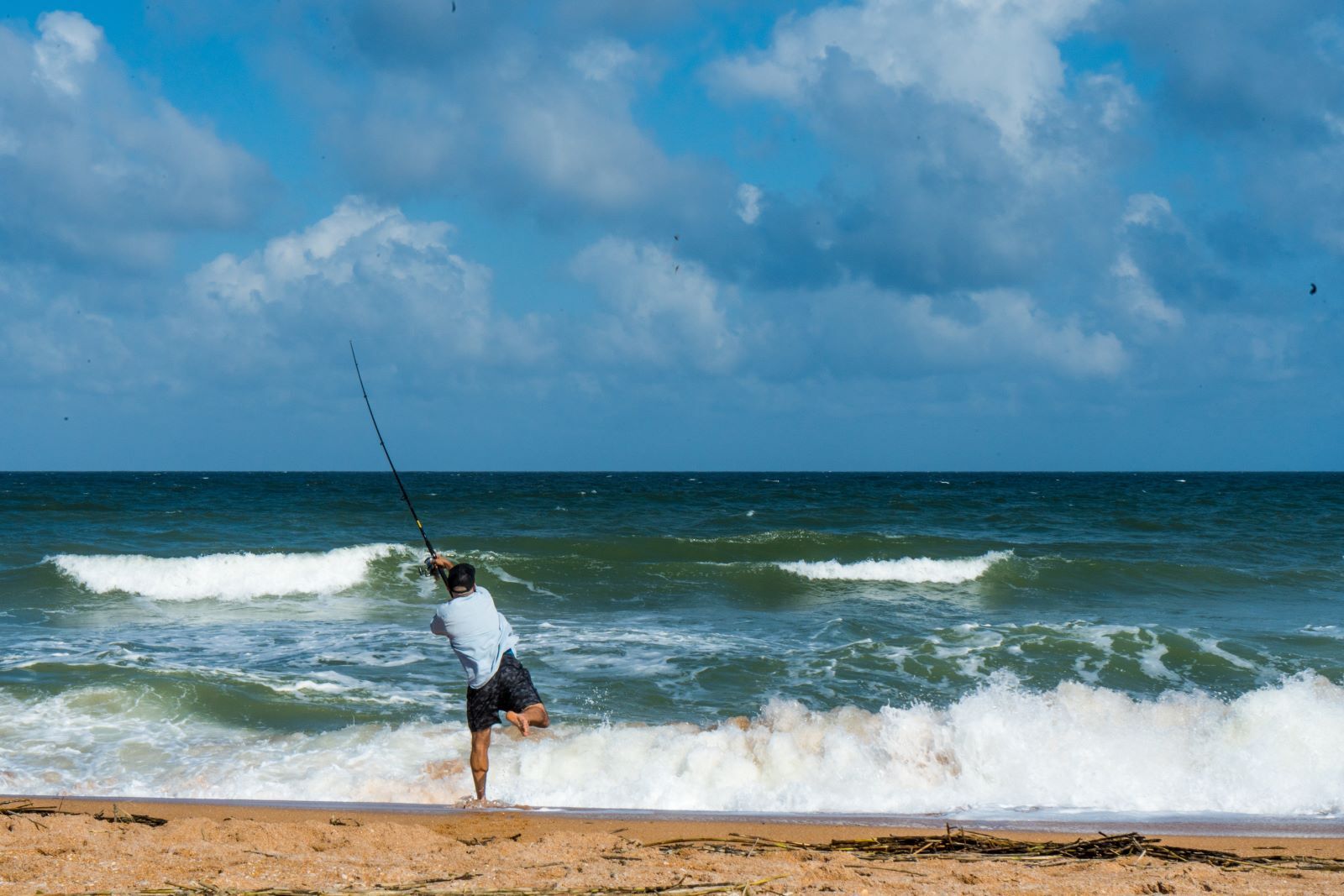 man surf fishing